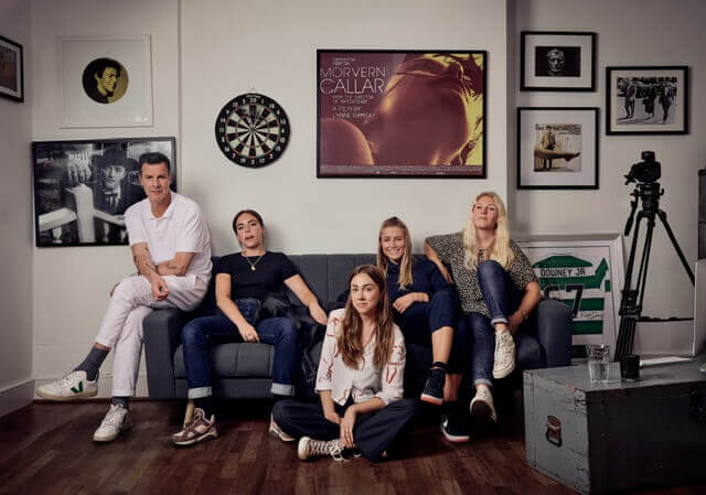 Casting Director Des Hamilton on a couch with the team.