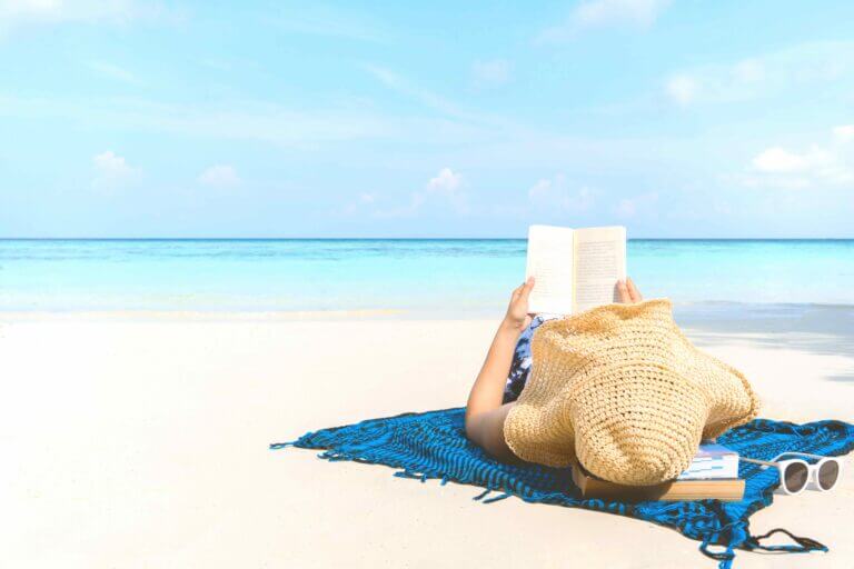 An actress working on their summer beach reads, specifically a memoir.