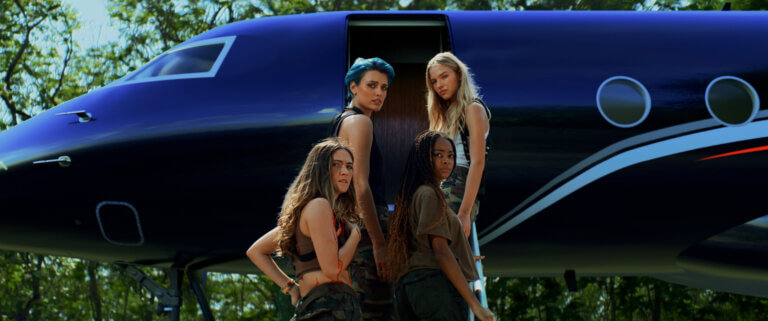 (L-R) Isabelle Fuhrman, Wallis Day, Skai Jackson and Sasha Luss outside in front of a blue helicopter.