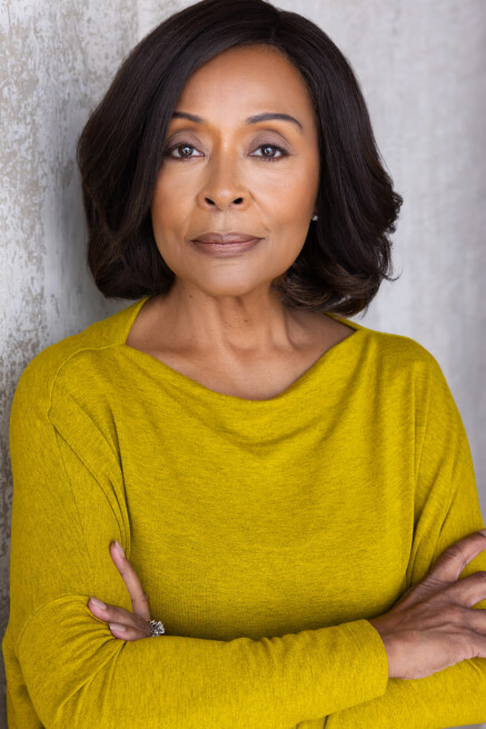 Actor Malena Cunningham Anderson smiling in a yellow sweater.