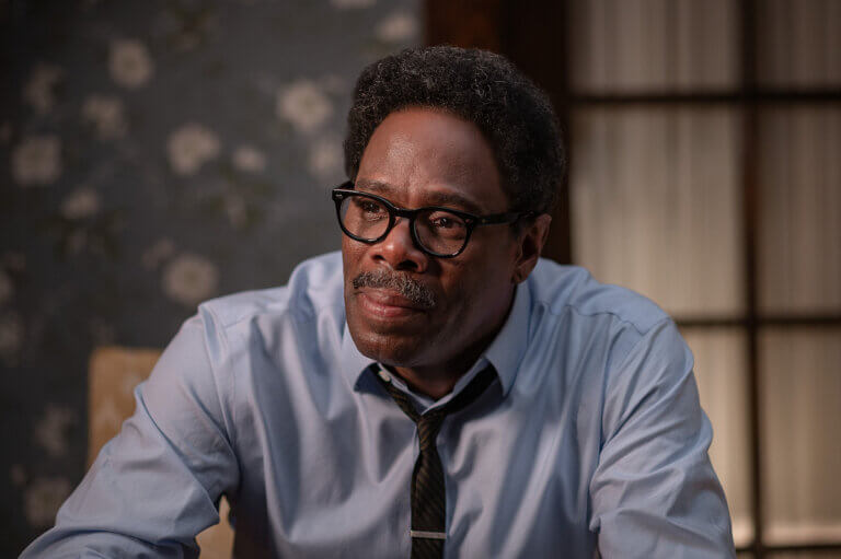 Coleman Domingo as Bayard Rustin sittign in a chair.
