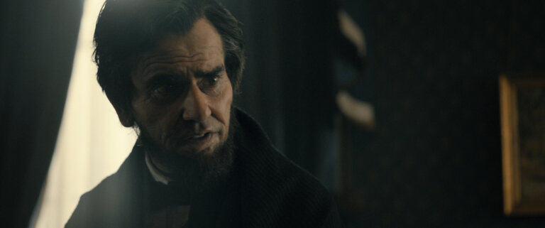 Hamish Linklater portraying Abraham Lincoln on a closed set.