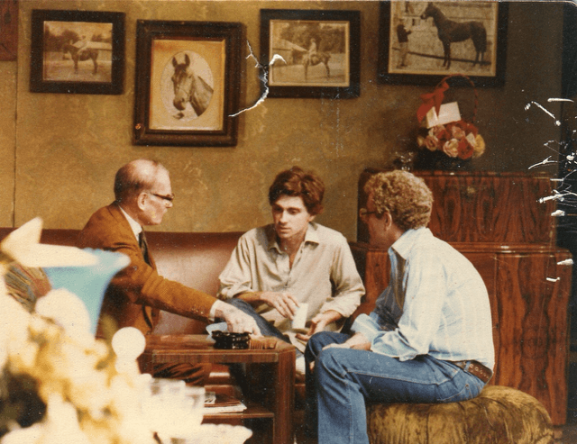 Dennis Boutsikaris on a couch performing with Laurence Olivier.