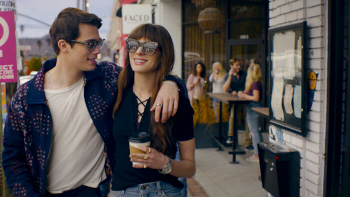 Nicholas Galitzine and Anne Hathaway walking together outside.