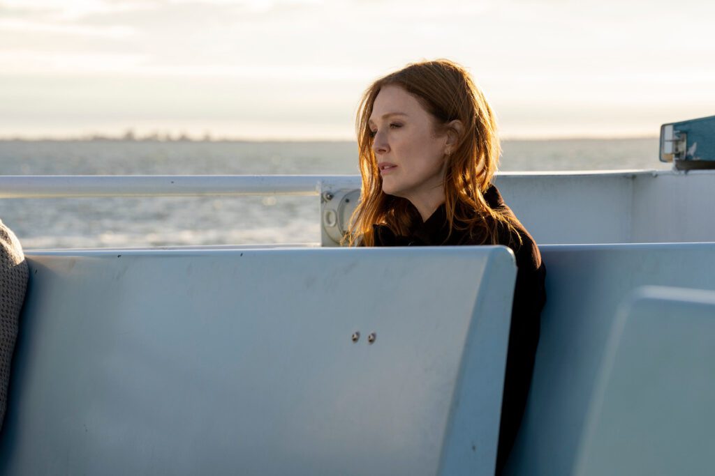 Actor Julianne Moore sitting on a boat crying in the show Sirens.